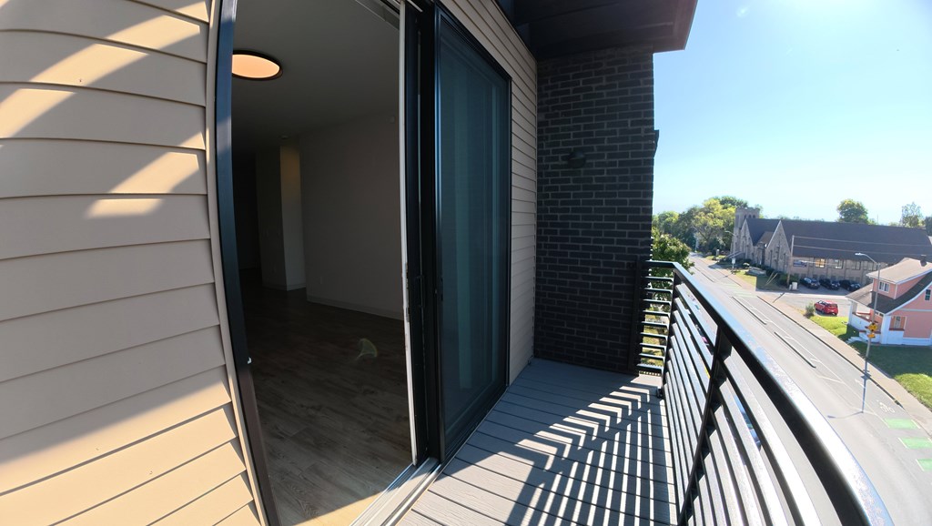 A balcony with a view of a residential area.