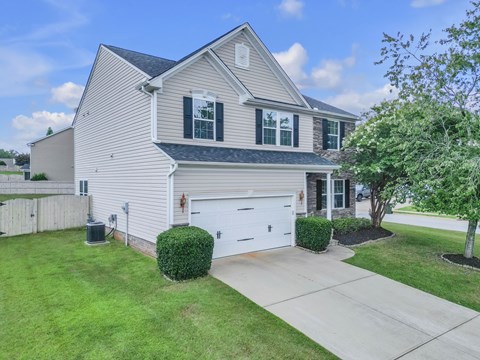 A house with a white garage door and a driveway.