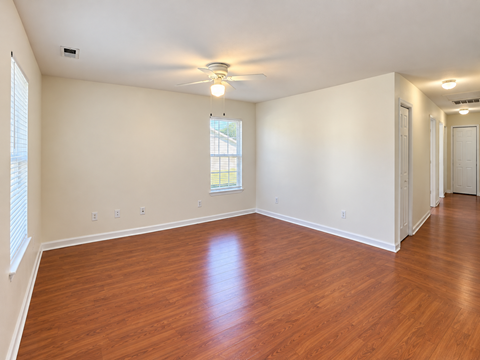 A room with wooden floors and white walls.