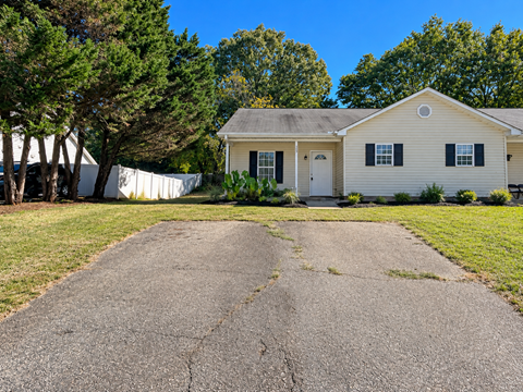 A house with a driveway in front of it.