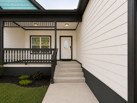 A small house with a black front door and a small window.
