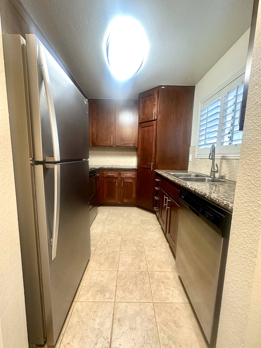 a kitchen with stainless steel appliances and wooden cabinets