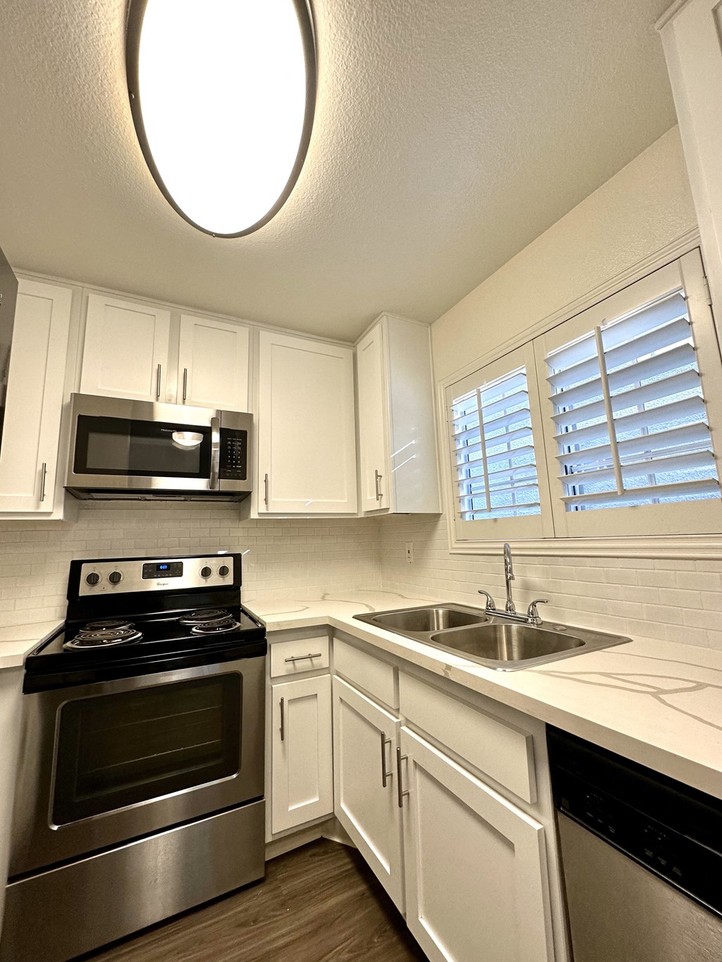 a kitchen with stainless steel appliances and white cabinets
