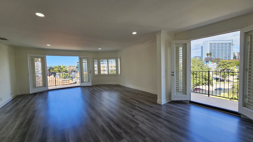 an empty living room with a view of the city