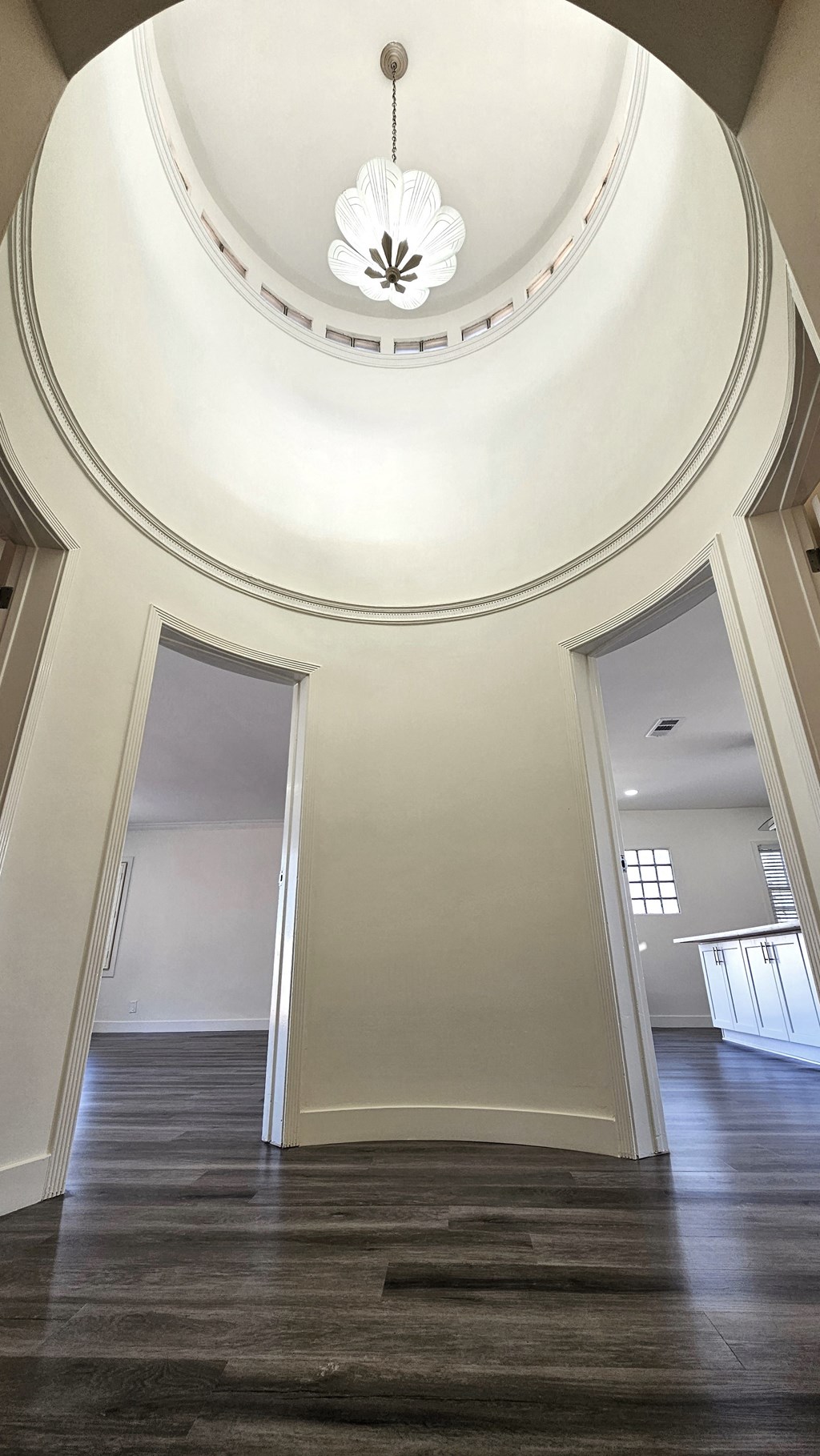 a view of a hallway with a large ceiling and a chandelier