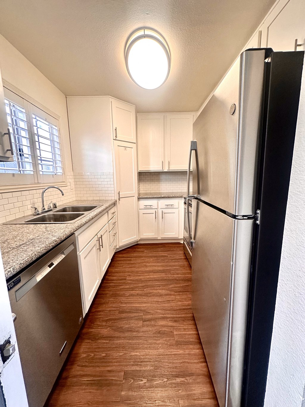 a kitchen with stainless steel appliances and white cabinets