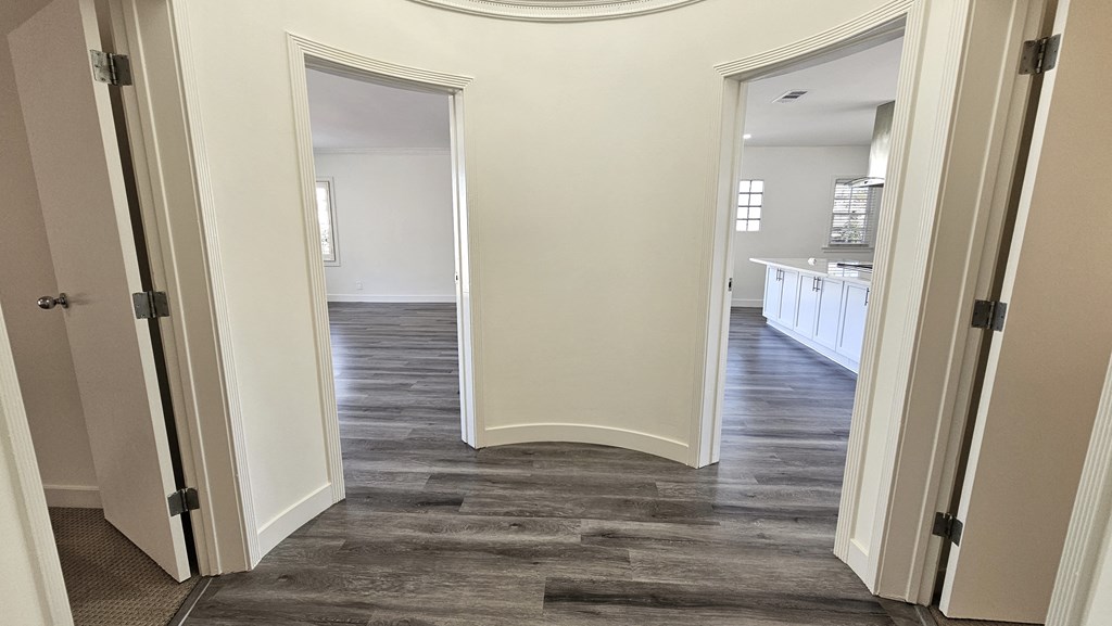 a view of the hallway from the living room into the kitchen