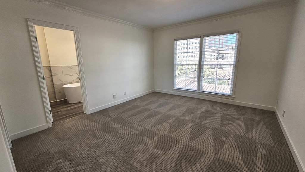 an empty living room with a large window