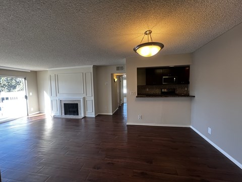 A living room with a fireplace and a television.
