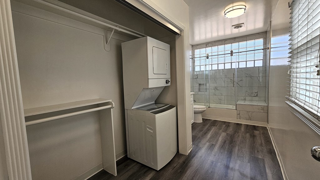 a small bathroom with a washer and dryer in it
