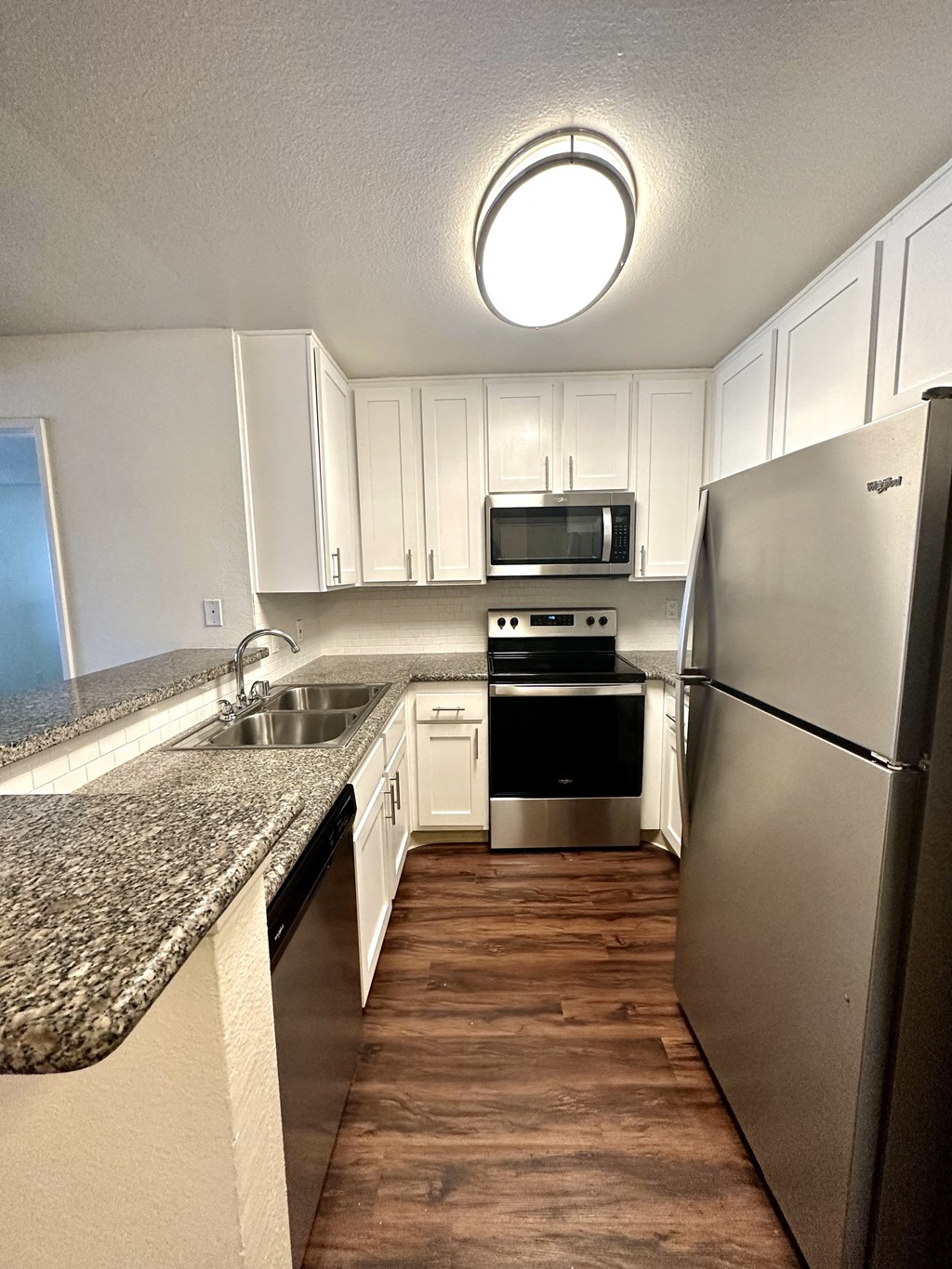 a kitchen with granite counter tops and stainless steel appliances