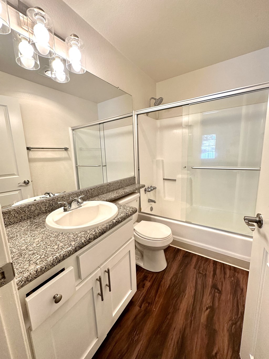 an empty bathroom with a sink toilet and shower