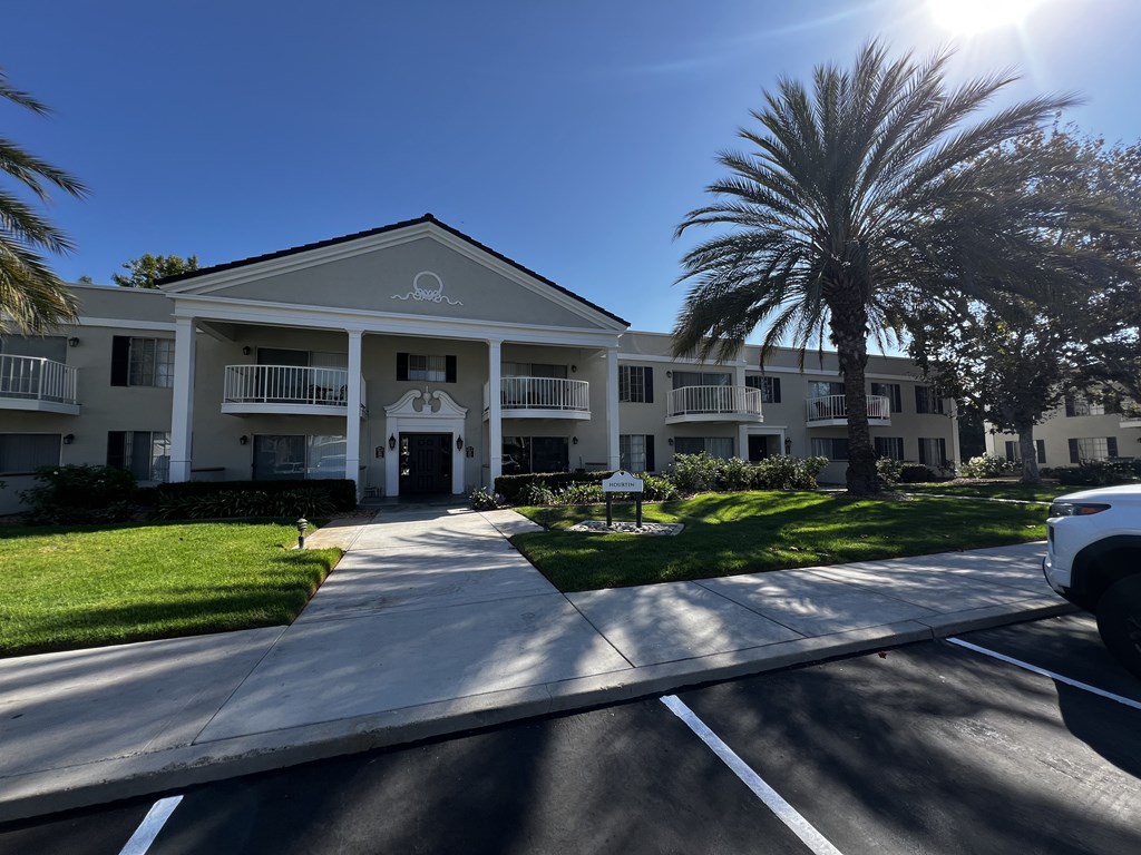A sunny day at the front of a building with the word "River" written on it.
