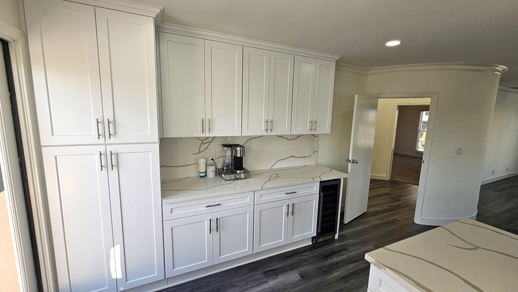 a recent kitchen remodel with white cabinets and black appliances
