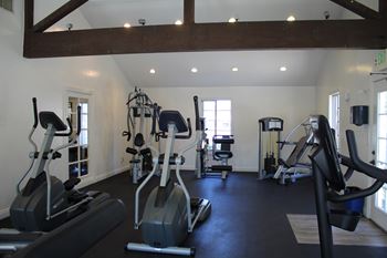 A gym with a variety of exercise equipment.