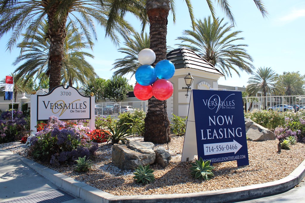 A Versailles sign is displayed in front of a leasing sign.