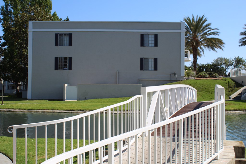 A white building with a white railing and a white staircase.