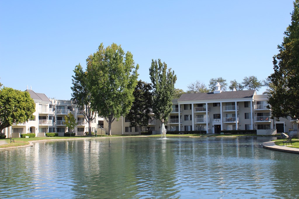 A large building with a pond in front of it.