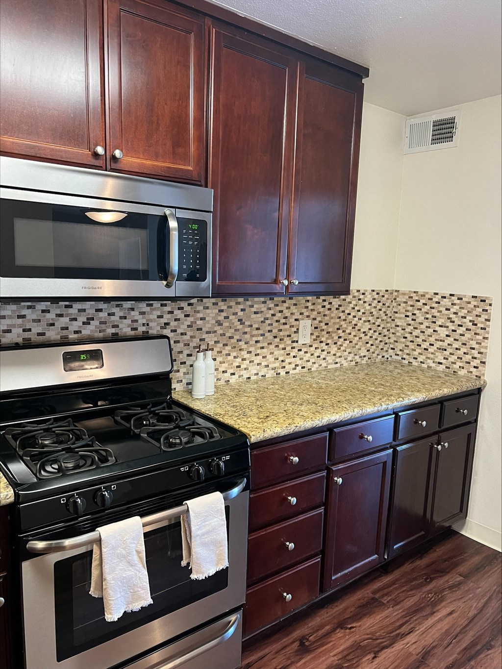 a kitchen with a stove and microwave