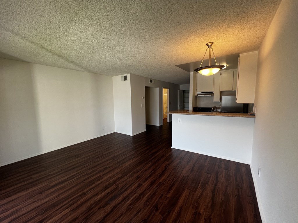 A room with wooden floors and white walls.