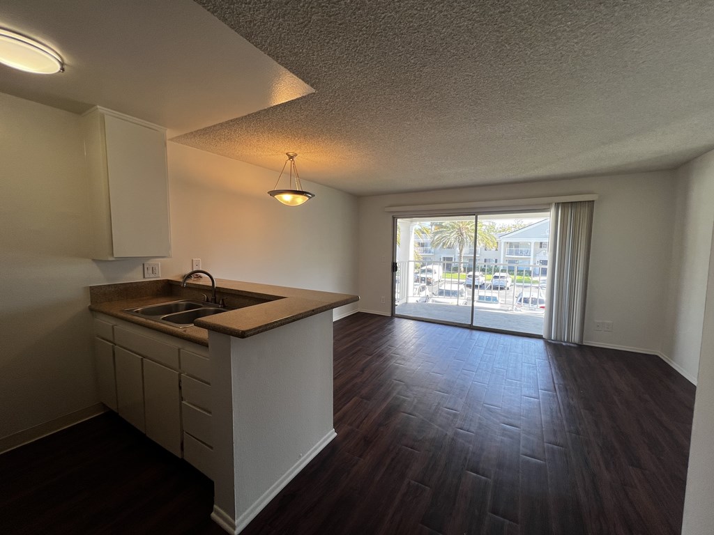 A kitchen with a sink and a window.