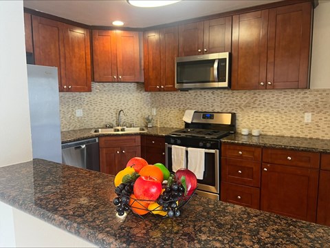 a kitchen with a bowl of fruit on the counter