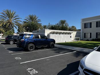 A blue truck is parked in a parking lot.