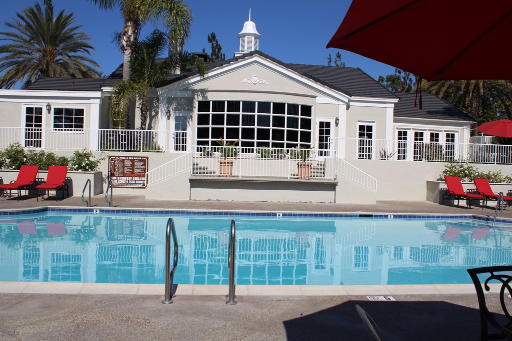 A pool with a building behind it.