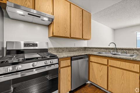 a kitchen with stainless steel appliances and wooden cabinets