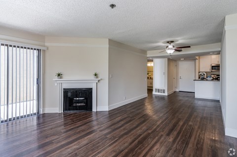 A living room with a fireplace and hardwood floors.