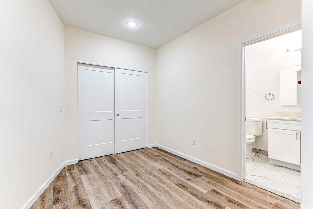 A room with a white door and a white cabinet.