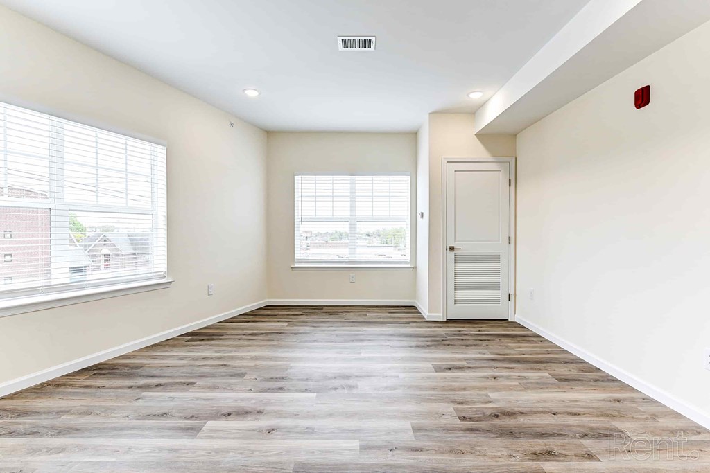 A room with a wooden floor and a white door.