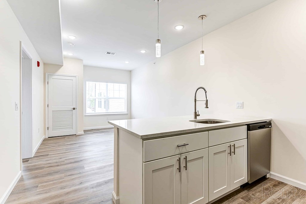 A kitchen with a sink and cabinets.
