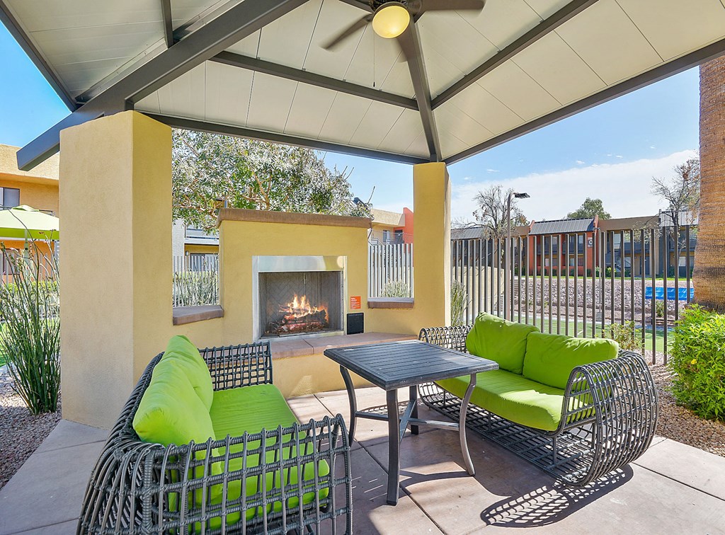 Outdoor fireplace and seating area under canopy at student apartments in Tempe, AZ