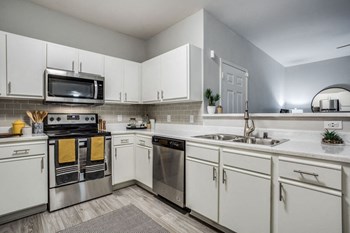 Beautifully appointed interiors with white cabinetry and stainless steel appliances Beautifully appointed interiors with white cabinetry and stainless steel appliances - Photo Gallery 2