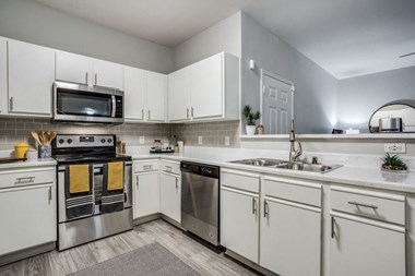 Beautifully appointed interiors with white cabinetry and stainless steel appliances