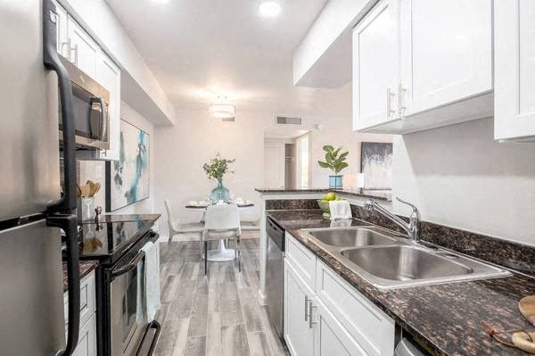 a kitchen with a sink and a refrigerator