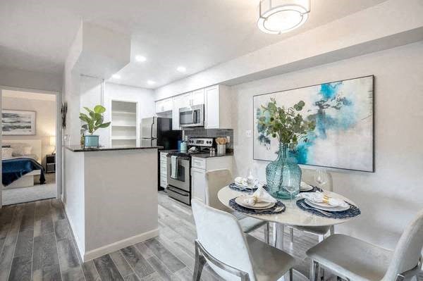 a kitchen and dining room with a table and chairs