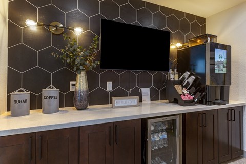 a kitchen with a counter and a tv on the wall