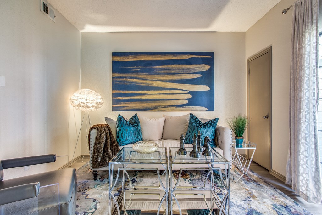 a living room with a couch and a glass table