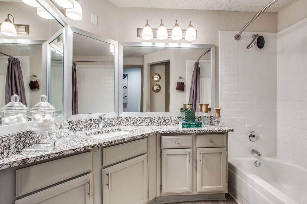 the preserve at ballantyne commons executive bathroom with granite counter tops and a tub