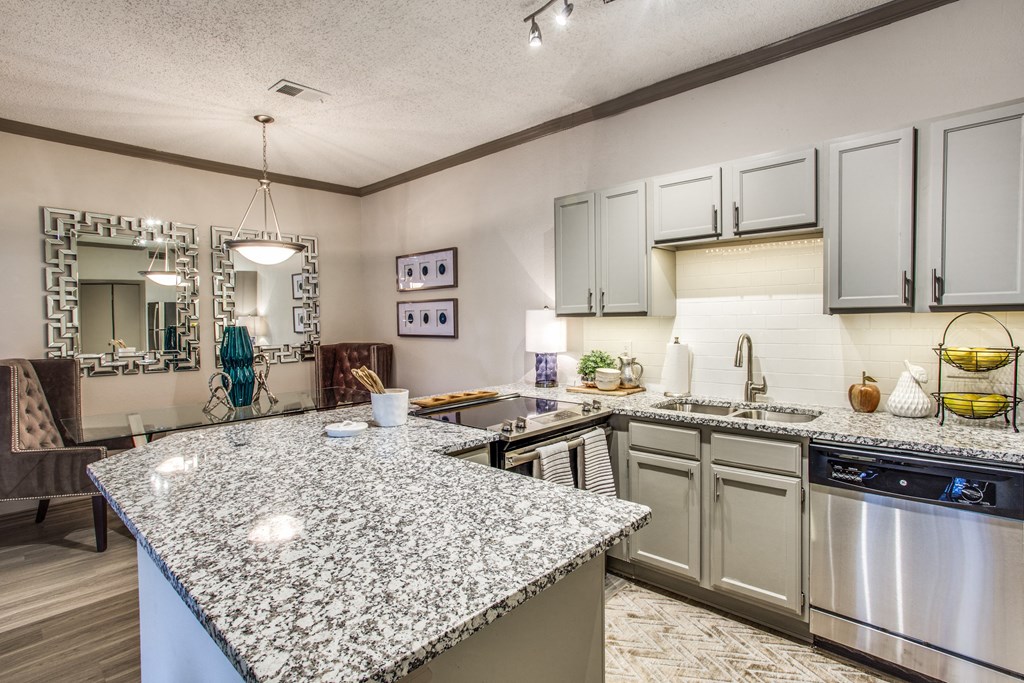 an updated kitchen with granite counter tops and stainless steel appliances