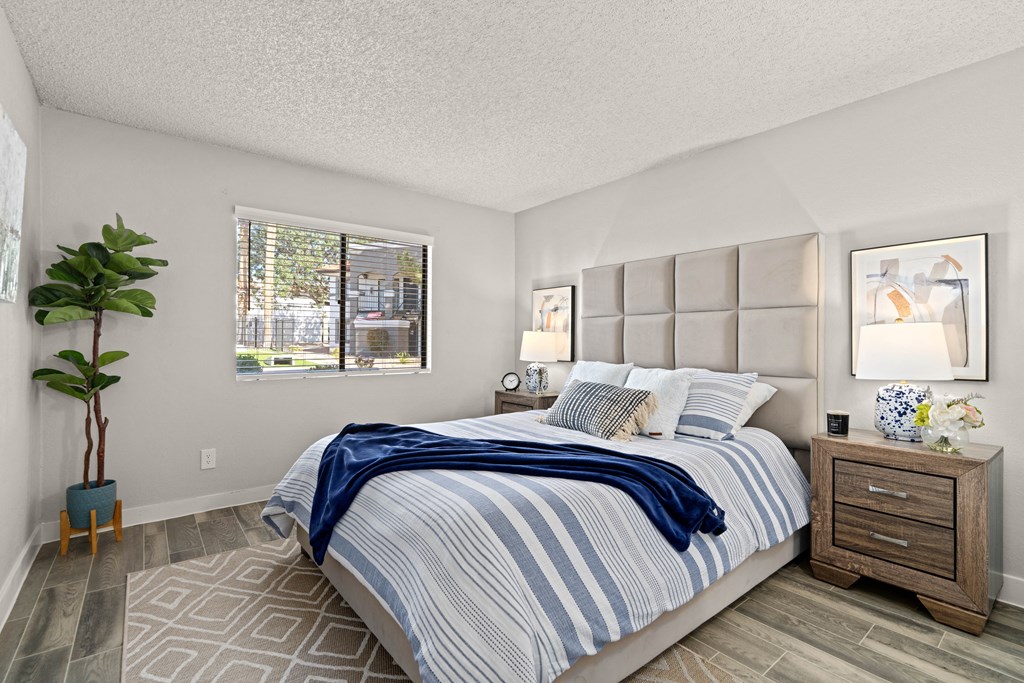 a bedroom with a bed and two night stands