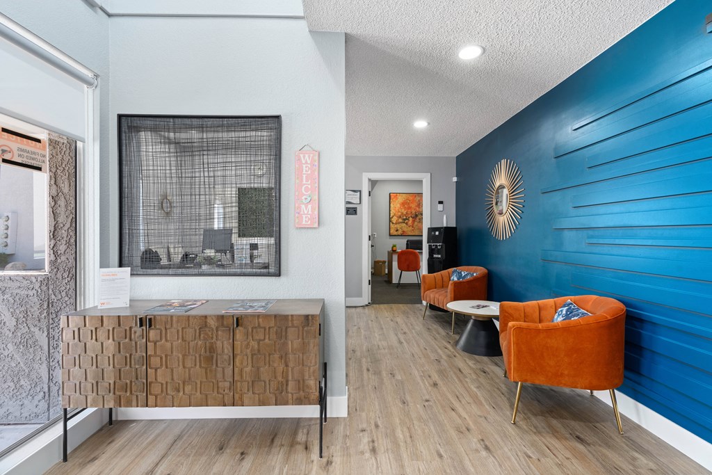 a room with a blue wall and orange chairs