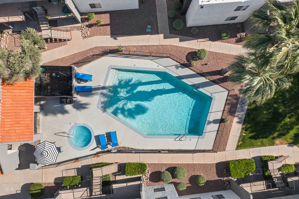 an aerial view of a swimming pool in a backyard