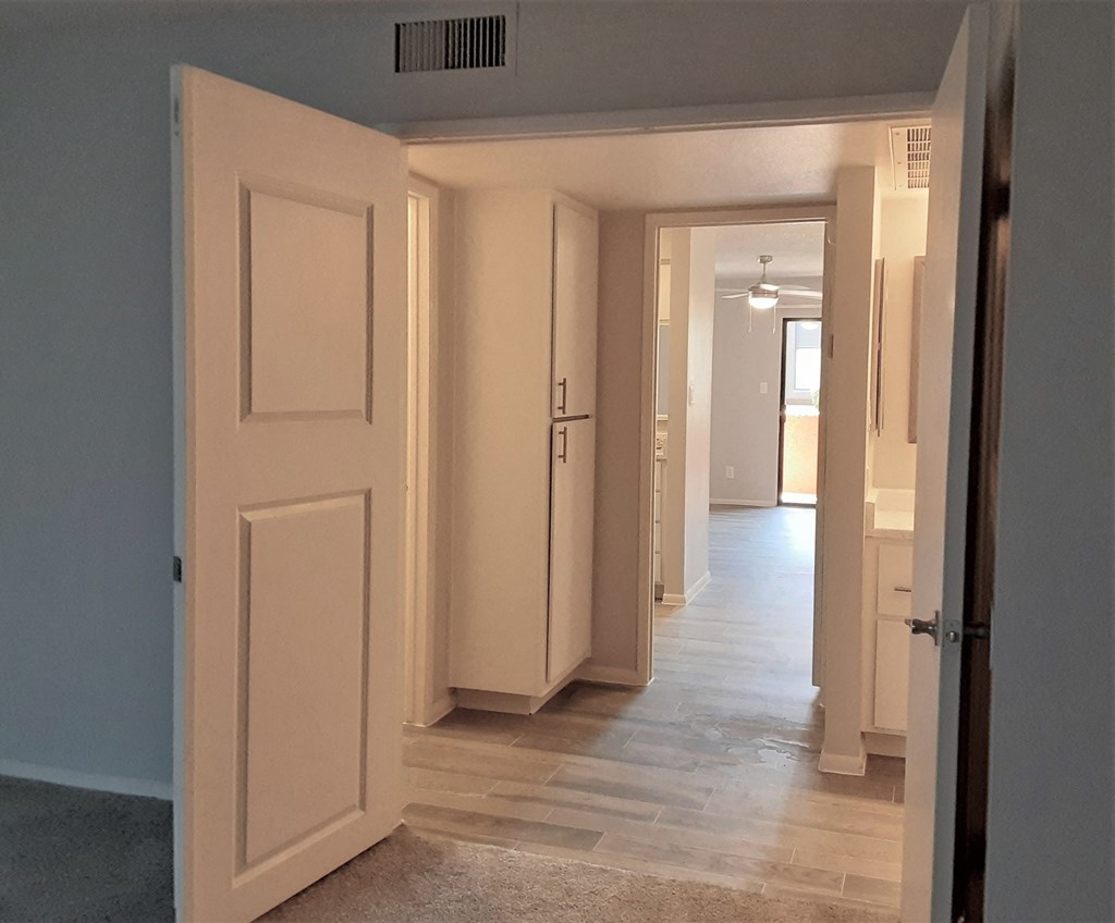 a view from the living room into the hallway and the bedrooms