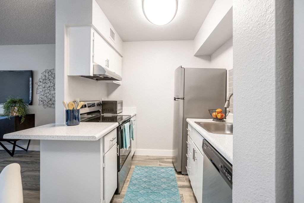 Phoenix AZ Apartments - Spacious Modern Kitchen With White Cabinets, White Countertops, and Stainless Steel Appliances
