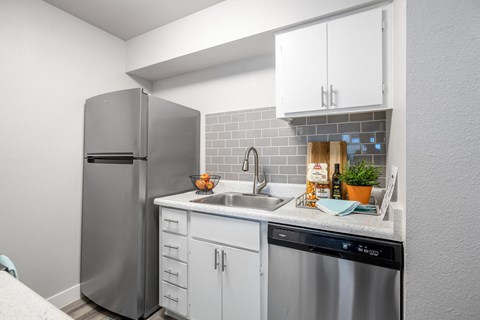 a kitchen with stainless steel appliances and a stainless steel refrigerator