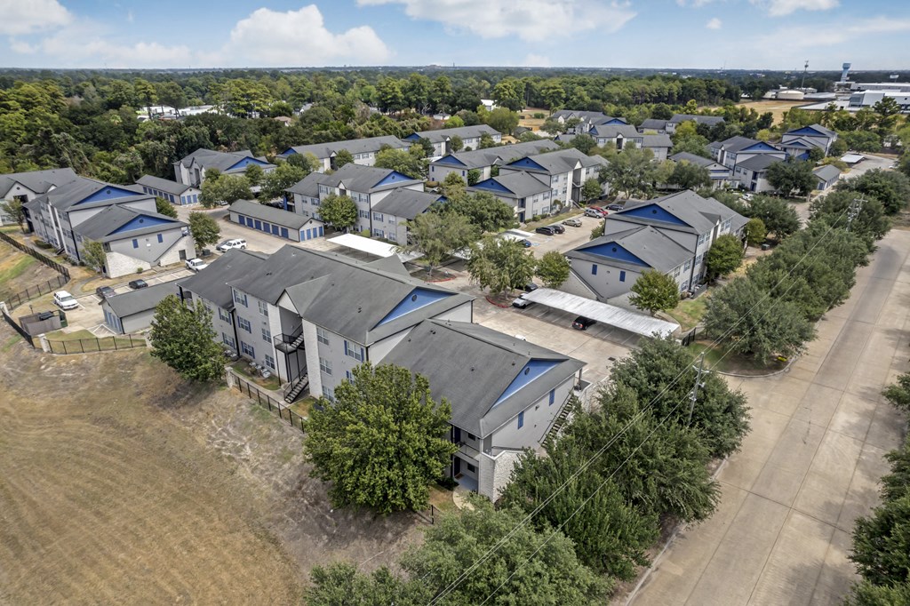 an aerial view of a neighborhood of houses with blue roofs