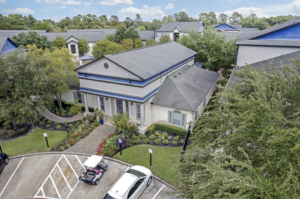 an aerial view of a house with a car parked in front of it